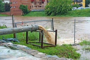 impressive exhaust flows into river rainwater and mud