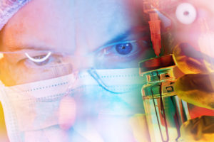 Medical researcher in protective mask using laboratory pipette for immunology vaccine research and microbiology testing